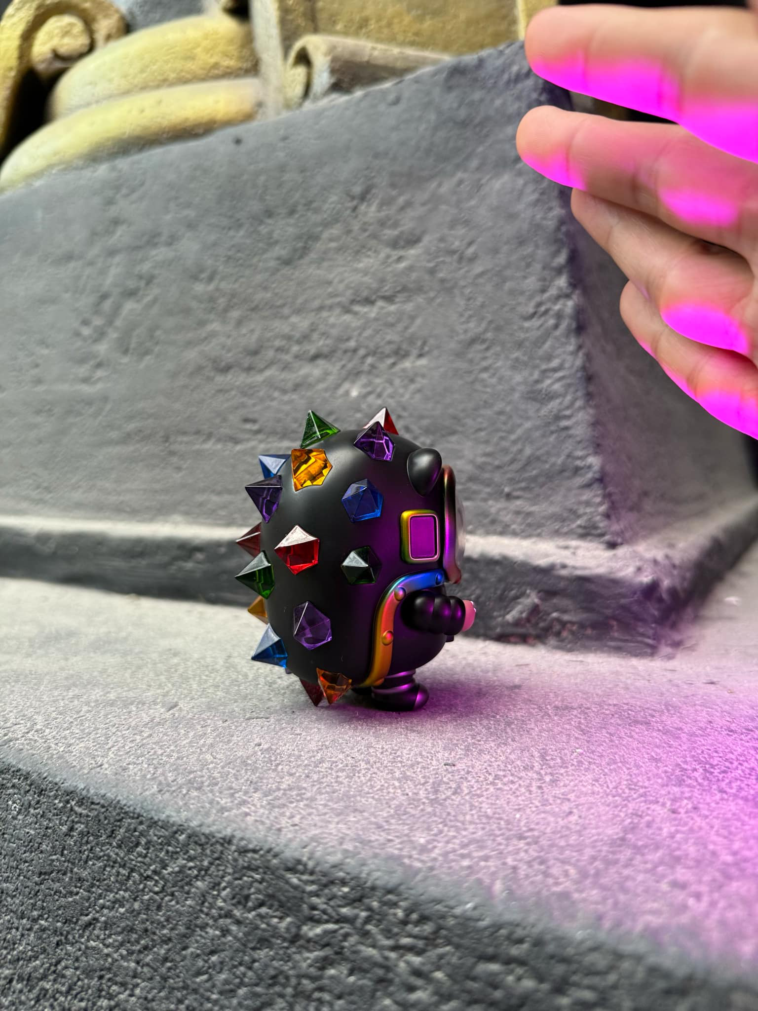 Space Hogkey Rainbow ver., a 9cm resin art toy, held by a hand, showcasing a unique diamond and triangle design.