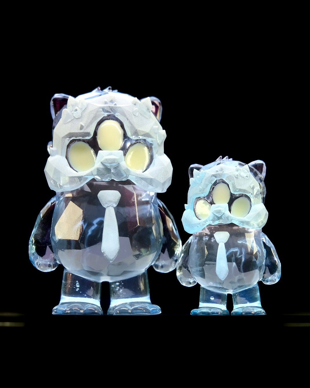 Beans Group Show - Arctic Beans by DTC Studios x Josh Divine features two clear resin figures, 5 and 3, resembling cartoon animals in suits and frosted masks.