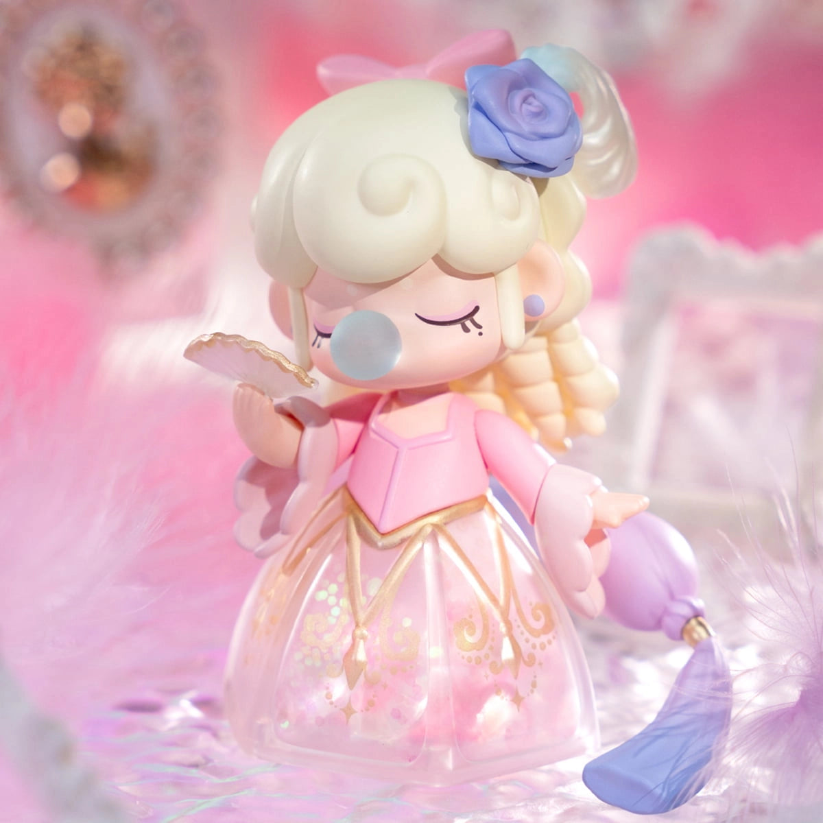 Nanci's Museum of Fantasy Blind Box Series: Pastel-princess vinyl figure with blonde curls, bubble, pink gown, holding fan and tassel. Part of a collectible set.