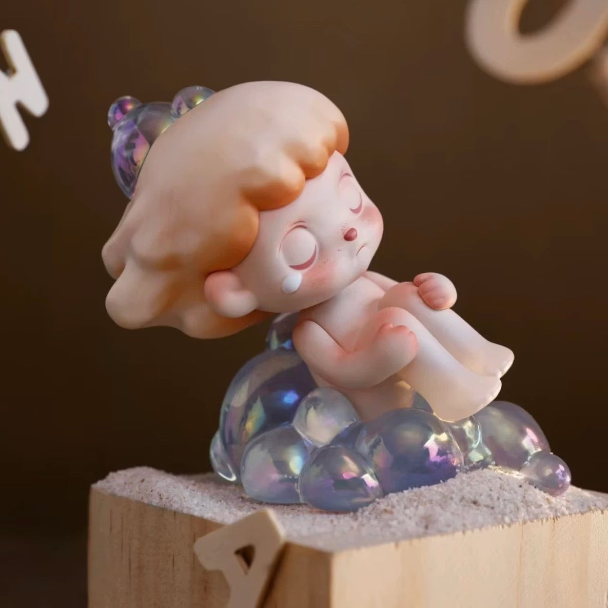 ANMOO Amo World is a Lie Fairy Tale Blind Box Series figurine, depicting a child sitting on a wooden block, available for preorder.