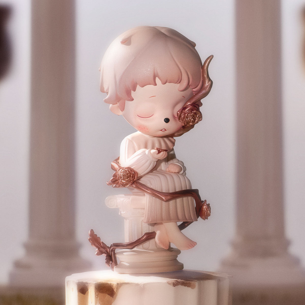 Inosoul In the Still Room Series Figure: a serene childlike sculpture on a classical pedestal, entwined with a metallic vine and rose blossoms.