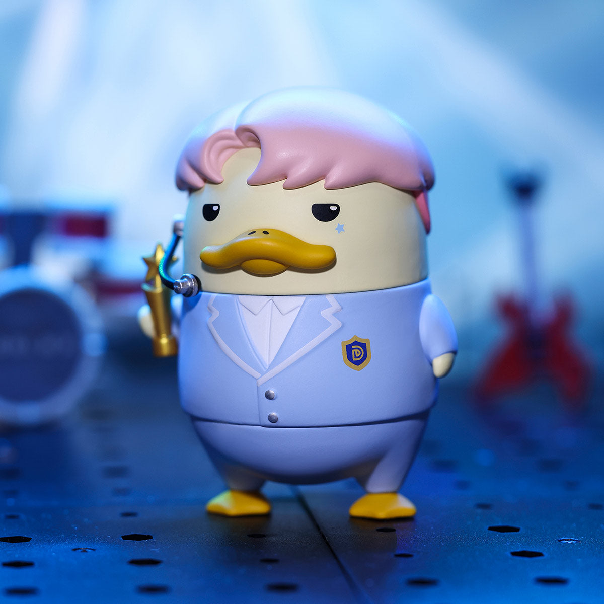 DUCKOO Music Festival Series figure in blue suit, holding a microphone on stage, surrounded by instruments. Preorder for October 2025 shipping.