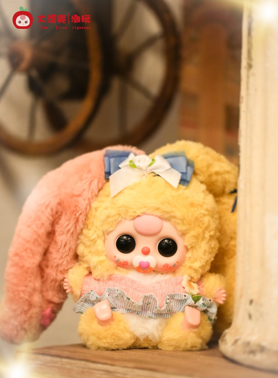 Baby Three - Lily Rabbit Town 4 plush toy in bunny costume with oversized eyes, pacifier, and musical-note cheeks, part of a collectible series.