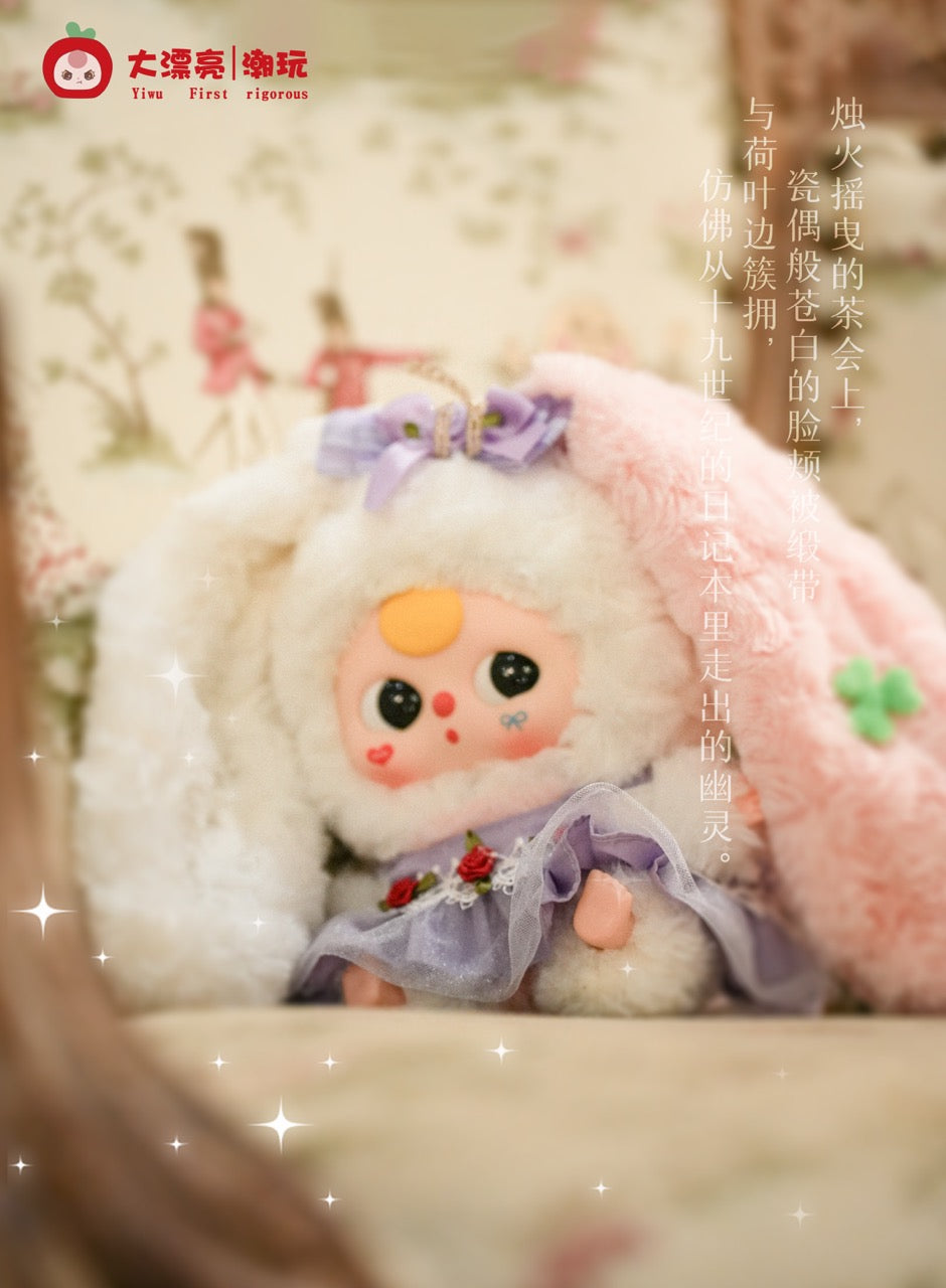 Chibi-style plush doll Baby Three - Lily Rabbit Town 4 with bunny hood and lilac dress, adorned with roses, against a pink blanket backdrop.