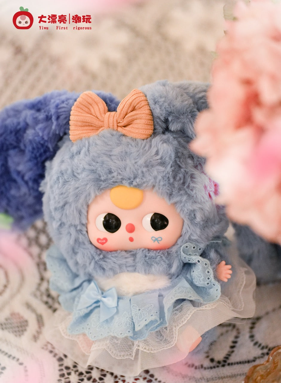 Baby Three - Lily Rabbit Town 4 collectible doll in a fluffy costume with floppy ears and lace dress, posed on lace with floral accents.