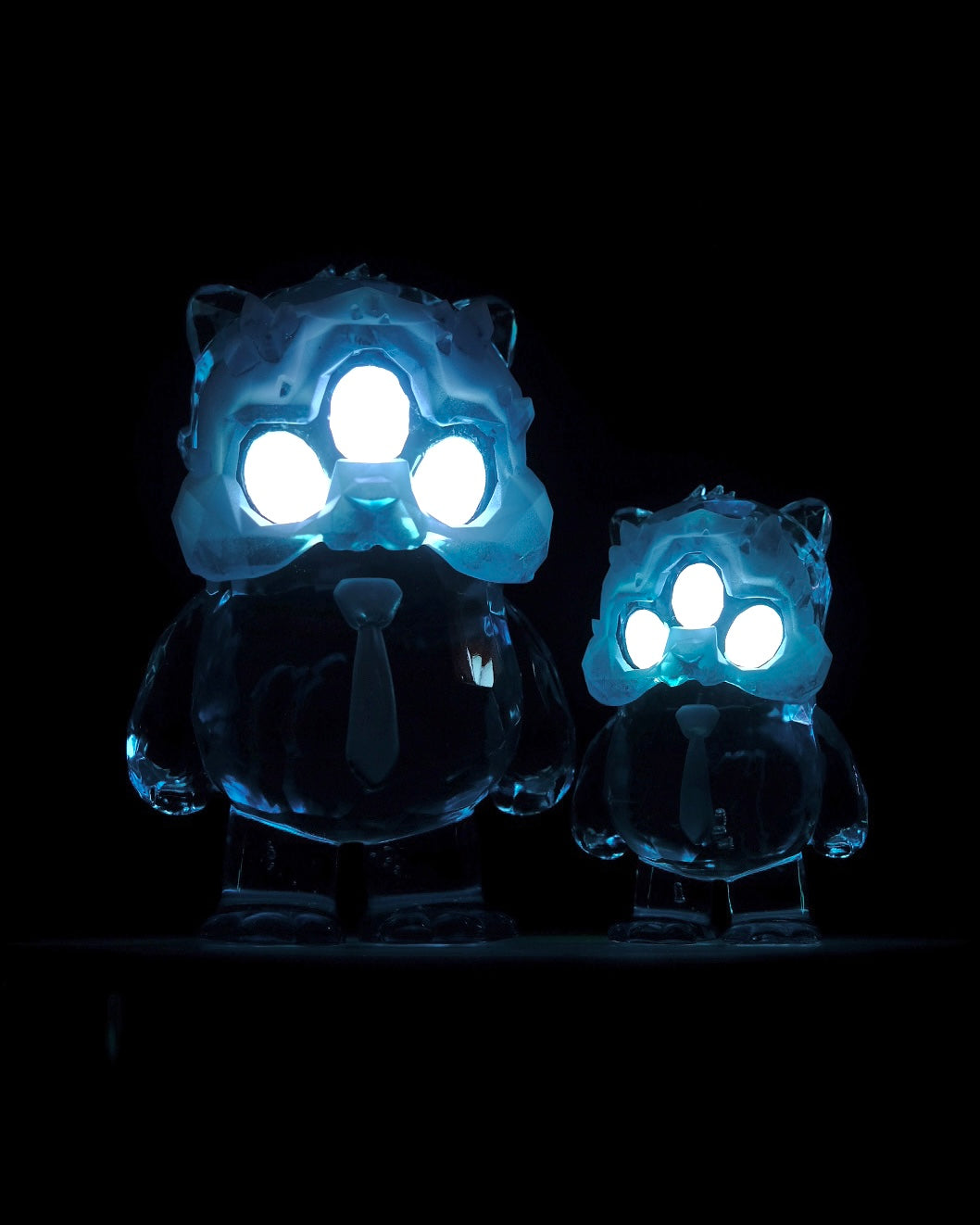 Beans Group Show - Arctic Beans by DTC Studios x Josh Divine, glowing translucent bear-like figurines with LED-lit masks, preordering now at Strangecat Toys.