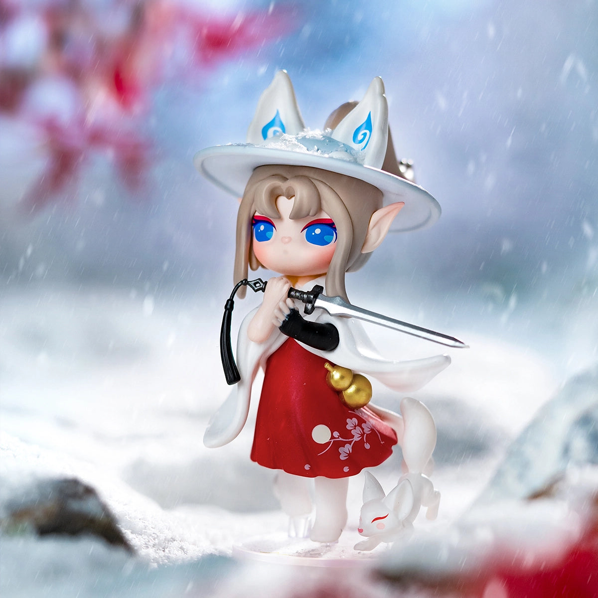 Chibi-style fox-eared elf figurine from Paradise Guardians Blind Box Series, featuring a snowy scene with sword and fox spirit companion.