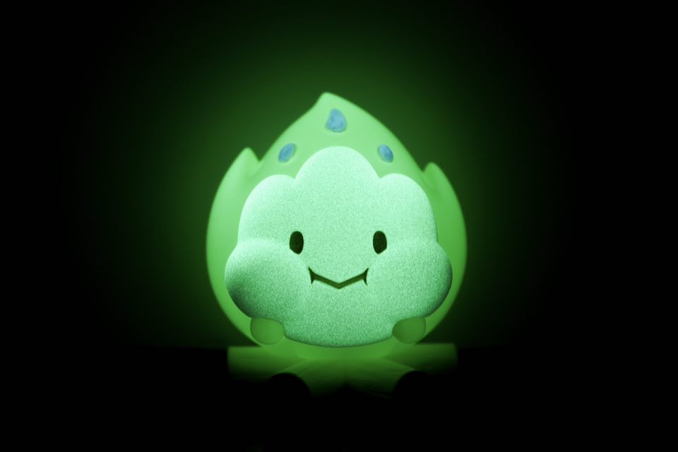 FLAMEY BON - Green Glow by MUPA Toy: A small, glowing green resin figurine with a cartoonish smile, available for preorder, shipping late October 2025.