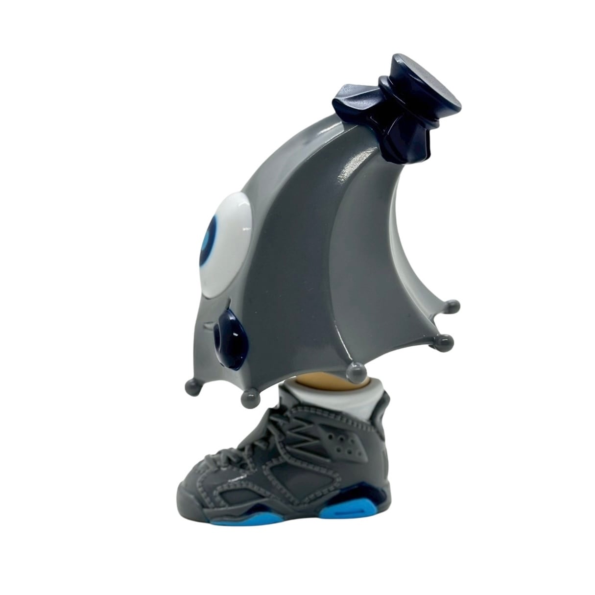 Kick Specter - grey by MARK's, featuring a droplet-shaped creature with a blue-eyed shell, standing on a gray sneaker, 12.5cm sofubi art toy.