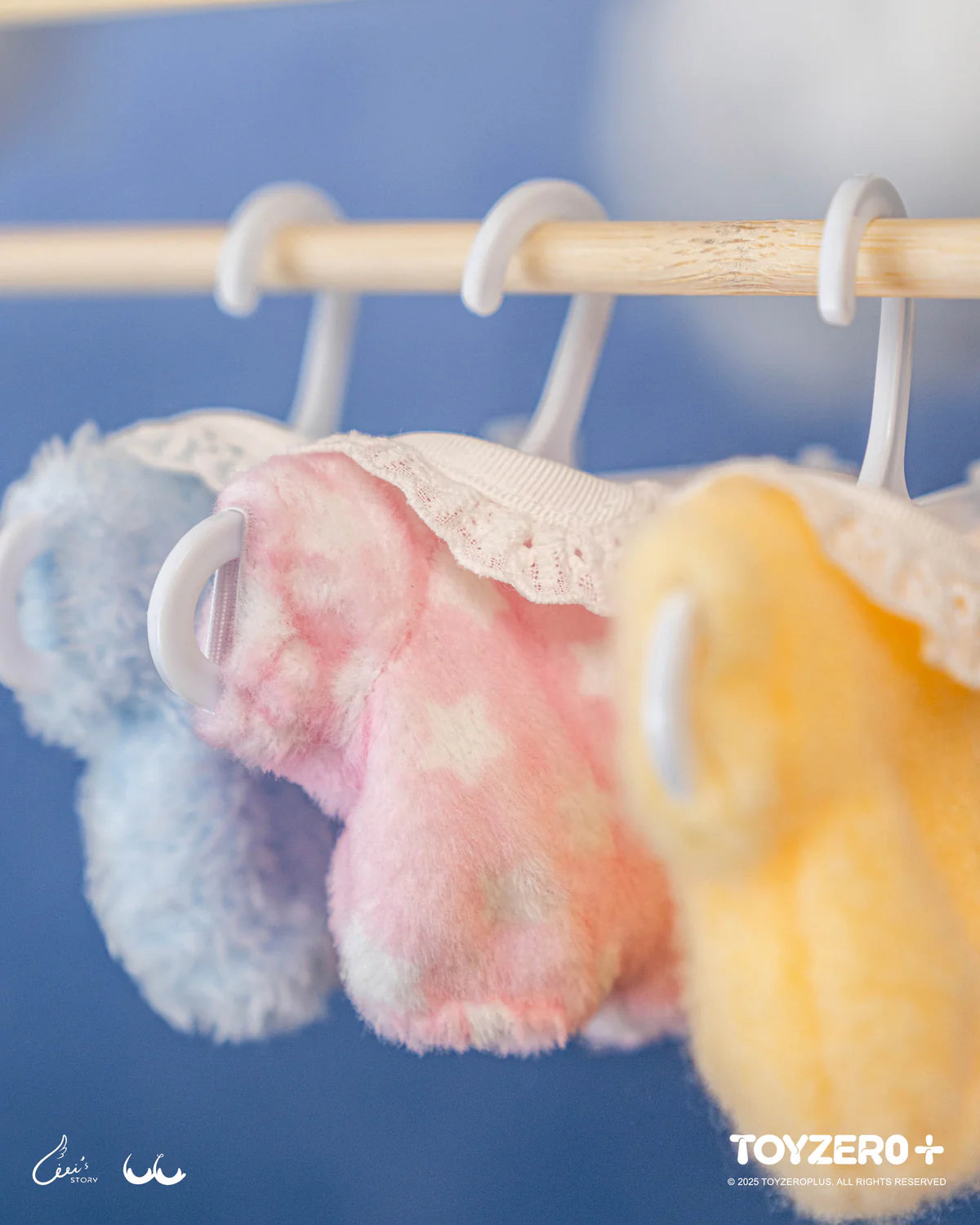 Three plush pastel garments hang, showcasing LuLu the Piggy - LuLu's Dreaming Wonderland Series PVC Plush Keychain Blindbox, a whimsical preorder art toy collection.