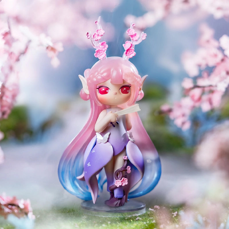 Paradise Guardians Blind Box Series figurine: fairy with pastel hair, antlers, cherry blossoms, petal outfit, butterfly accents, on a clear display base.