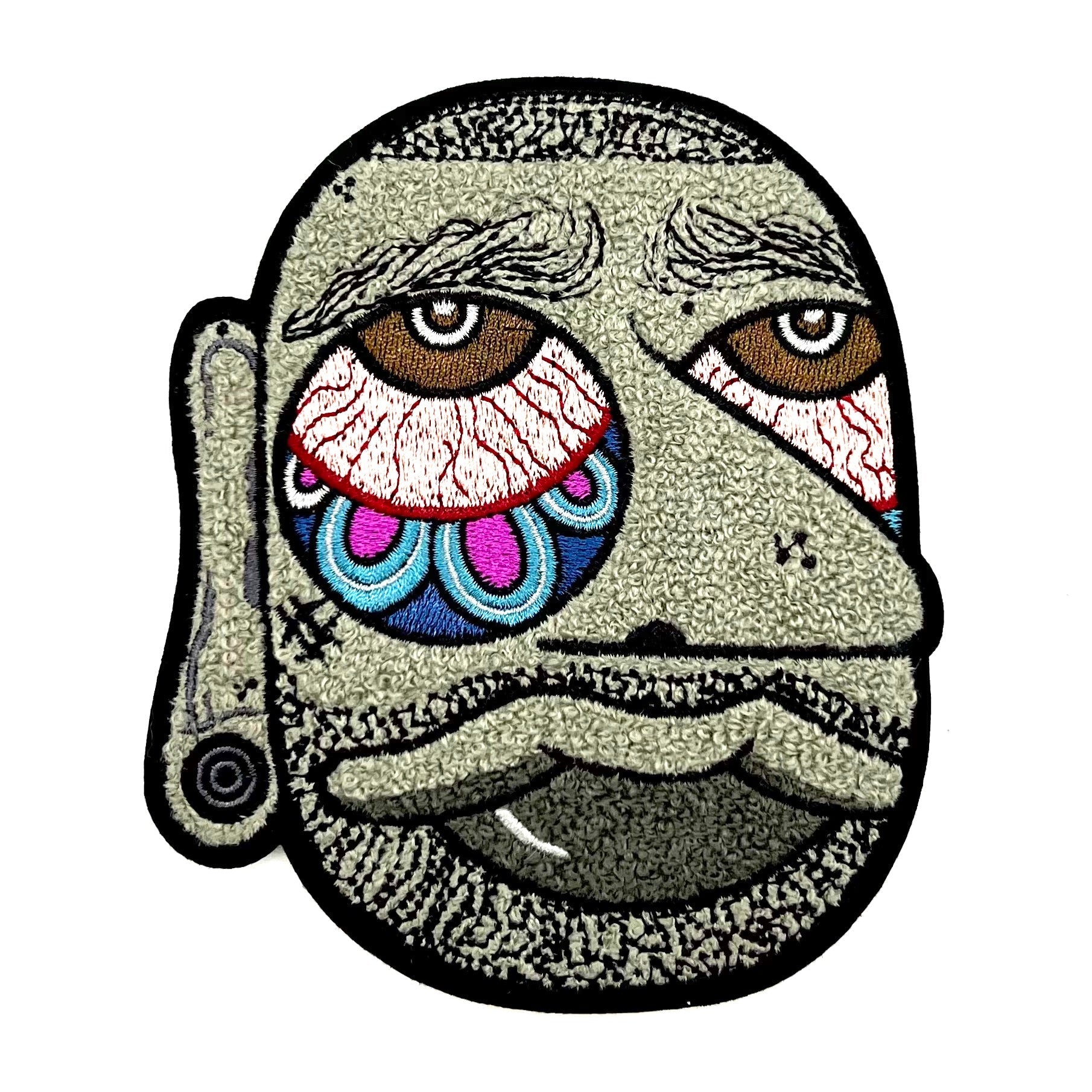 Blanco Chenille Patch, 5 tall, features a stylized face with a playful expression, perfect for art toy enthusiasts. Includes iron-on backing for easy application.