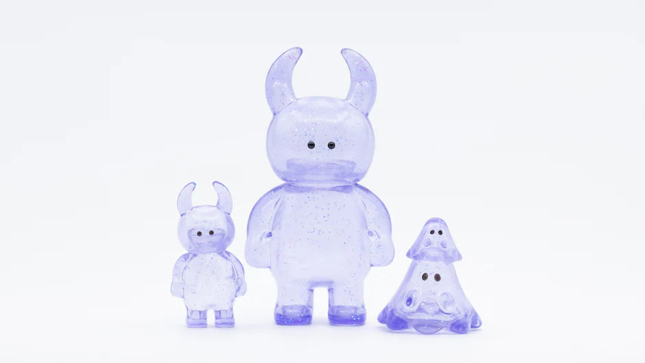 BOO CLEAR LAVENDER GLITTER: Trio of glossy, glittery lavender art toys; two horned creatures and a tiered ghost figure, crafted from soft vinyl, 2cm tall.