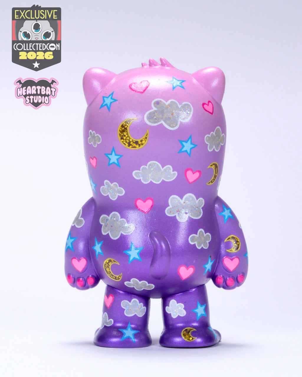 Back view of Beans Group Show - Care Beans vinyl art toy by Heartbat Studio x Josh Divine, featuring holographic clouds, moons, stars, and hearts. Exclusive Collected Con 2026 release.