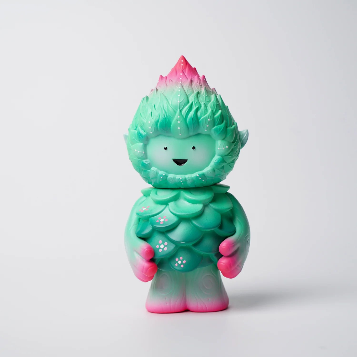 MUJUWORLD TREE SPIRIT SPRING EDITION preorder, a 4 whimsical vinyl figure, features minty green to pink leaf-like layers and a smiling face, designed by Mujuworld.