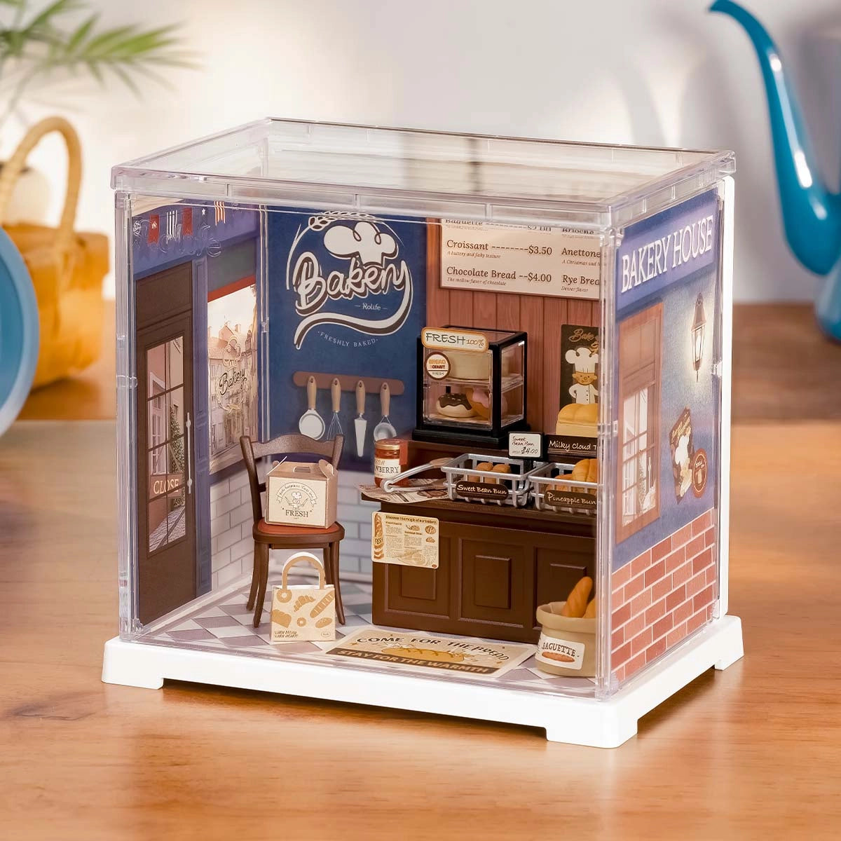 Rolife Mini Super Creator DIY Miniature House - Shop Series: Intricate bakery diorama with tiny breads, pastries, accessories, and signage, encased in a clear box.