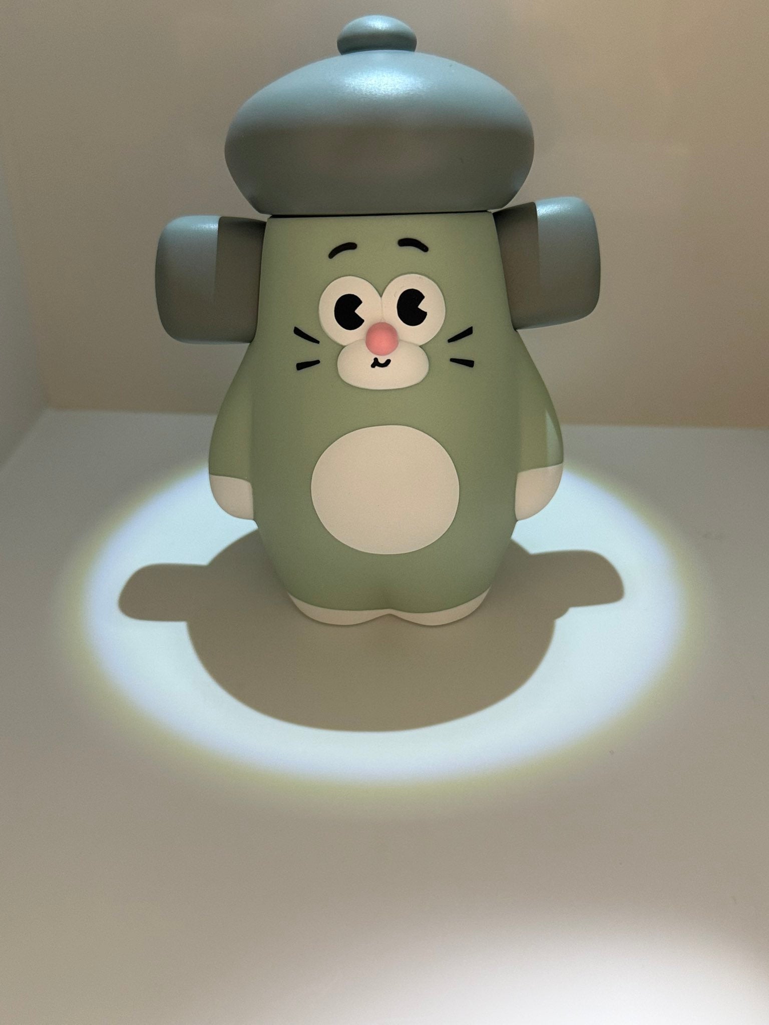 OHIGE no PON Mouse night-light, a mint-green, chubby rodent toy with a mushroom cap, casting a gentle glow on its base.