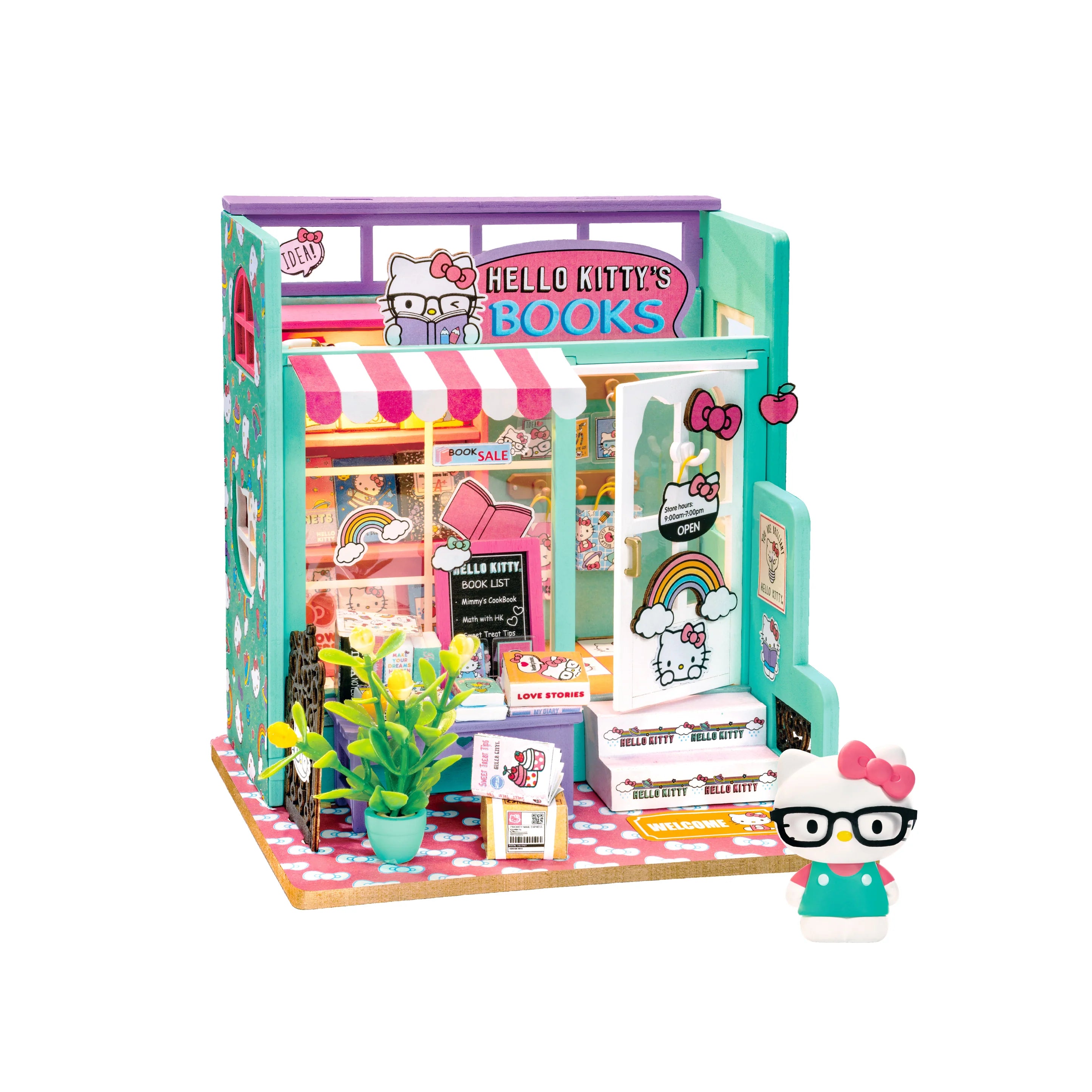 Hello Kitty® Bookstore diorama with awning, bookshelves, figurine in glasses, potted plant, chalkboard sign, and LED lights. Collectible model kit for crafting enthusiasts.