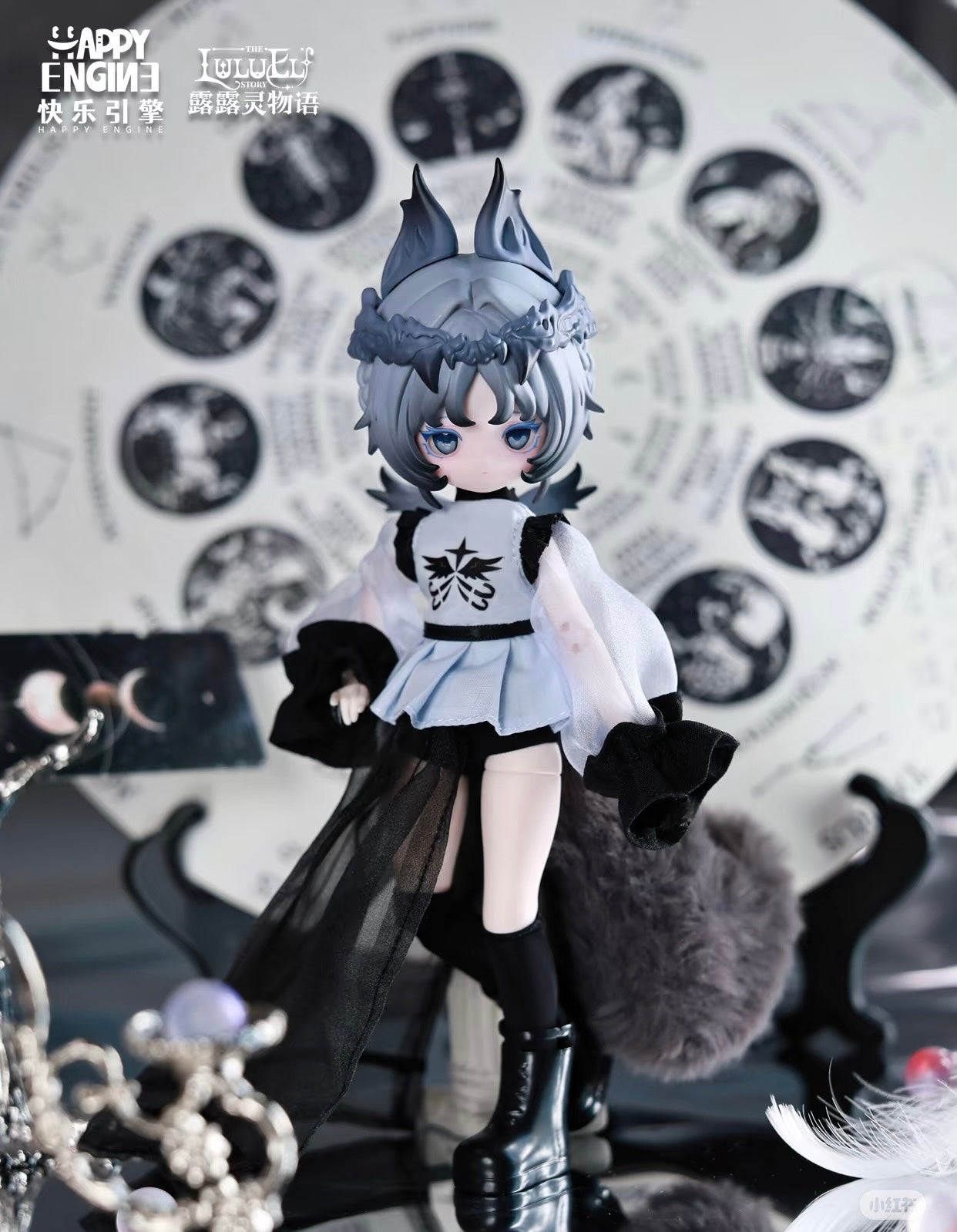 Luluelf Story BJD: Fox-eared figure in black and blue outfit with astrological backdrop, featuring a grey tail and crown. Preorder collectible by Happy Engine.