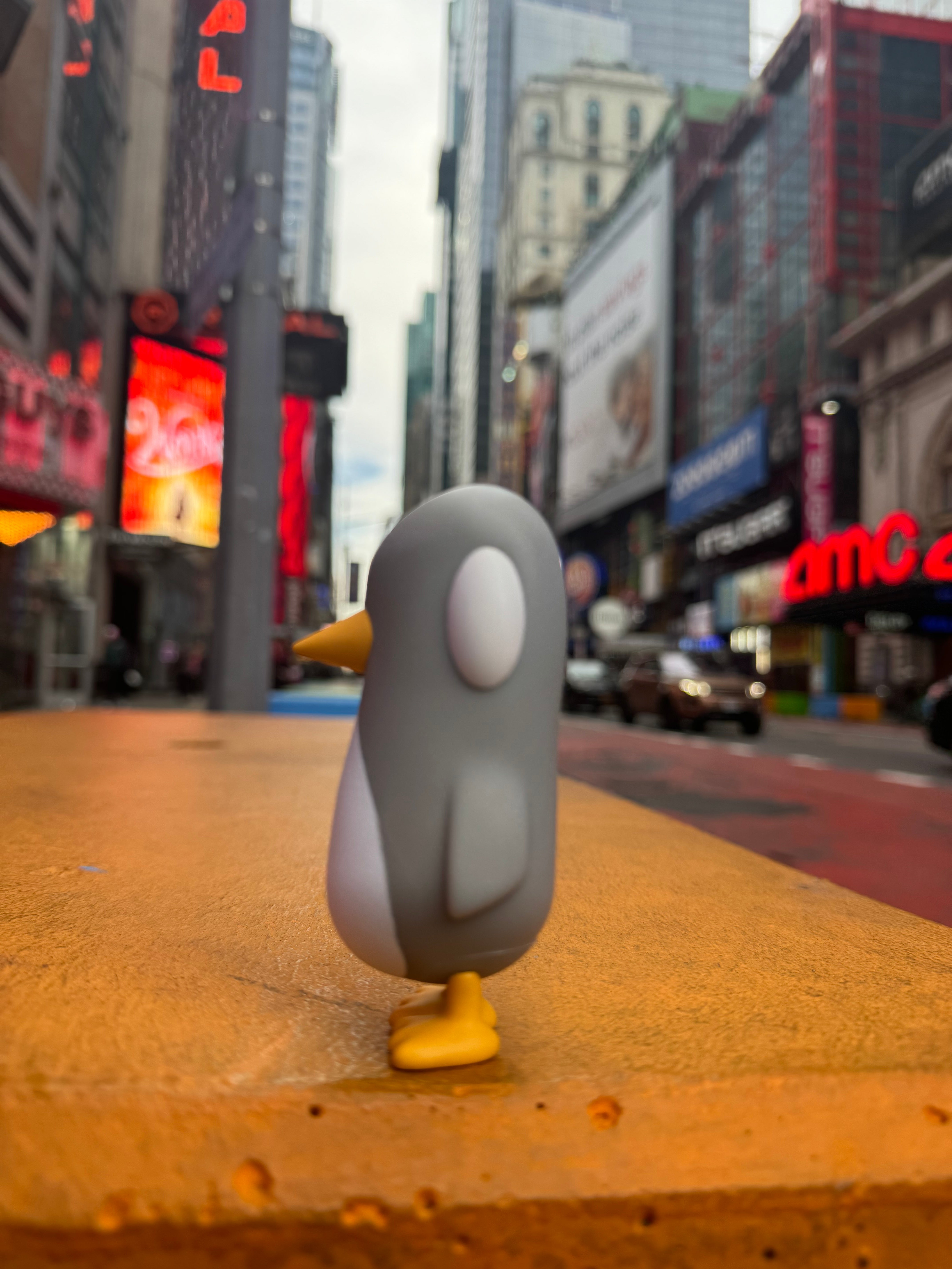 Old Friend - Gray Days Edition by Chris RWK, a vinyl toy penguin, displayed on a table. Limited edition art piece, part of Strangecat Toys' collection.