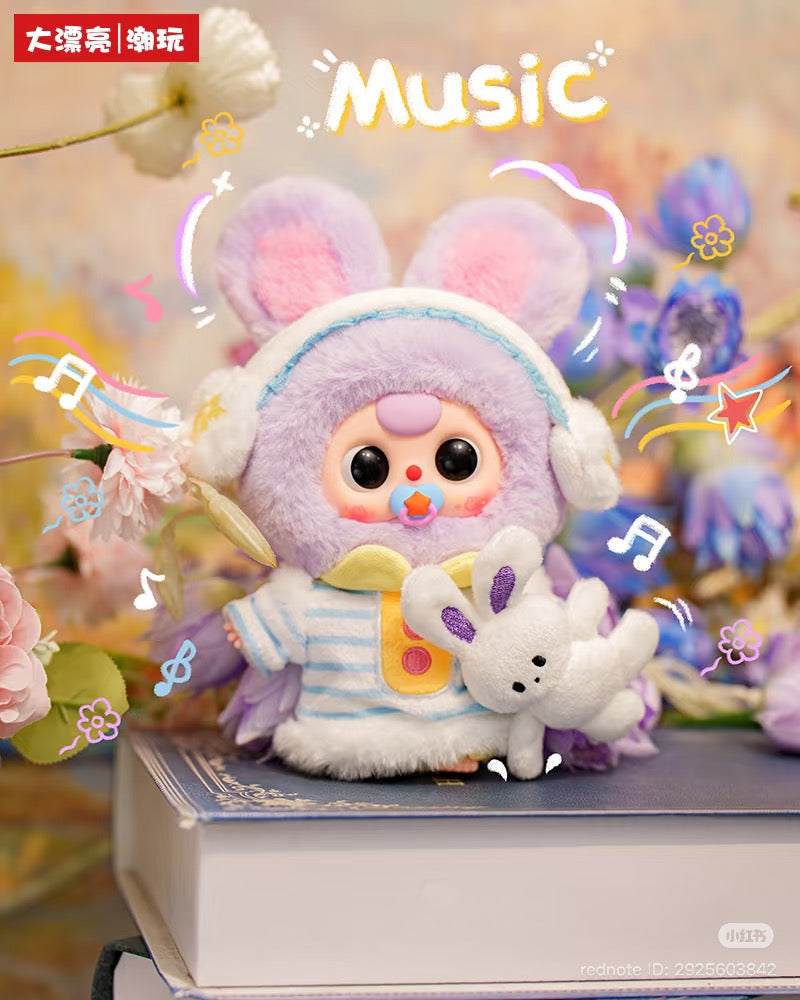 Baby Three - Sweet Dreams Plush Blind Box: A plush figurine in bunny-ear hood and striped pyjamas, holding a mini bunny, set atop books with doodles.