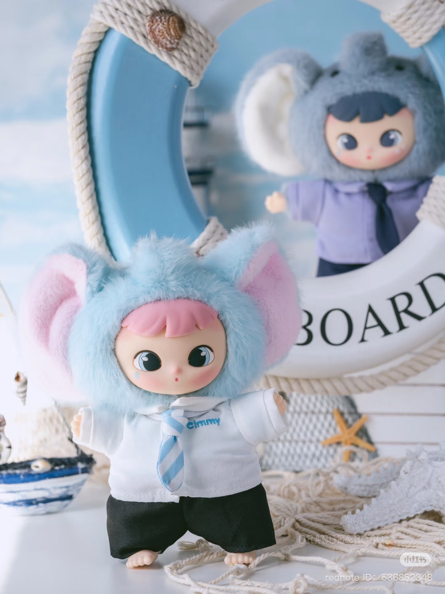 Cimmy You're Invited Series Plush Keychain Blind Box featuring a toy doll with a blue and pink fur hoodie, part of a collectible set.