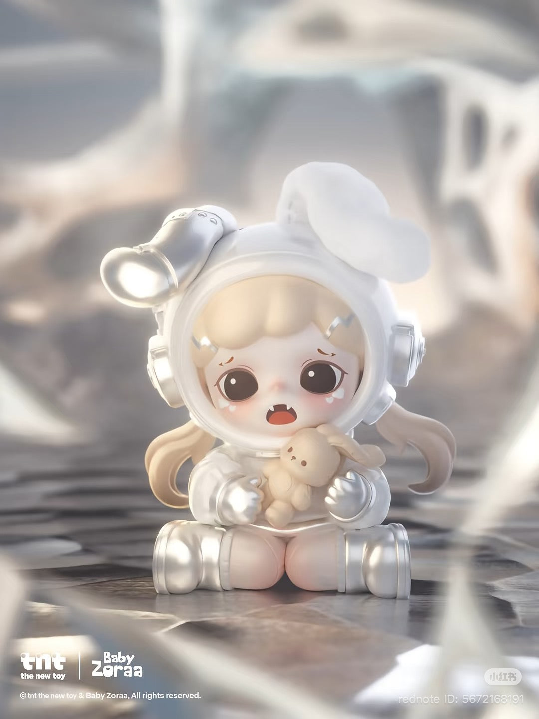 Baby Zoraa figurine in a glossy spacesuit with bunny ears, sitting on a moonscape, holding a bunny plush. Part of the Zoraa Starry River in Memories series.