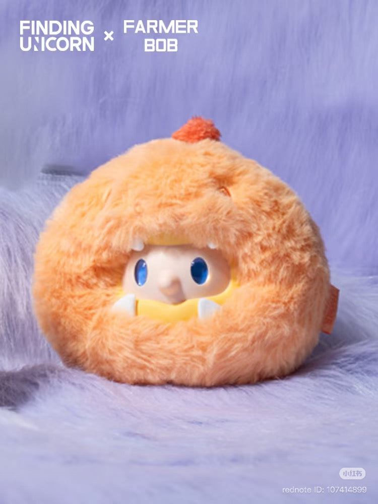 FARMER BOB Mini - DRAGON MIRAGE SERIES: Orange plush toy with a doll's face, blue eyes, white fangs, part of a collectible blind box series.