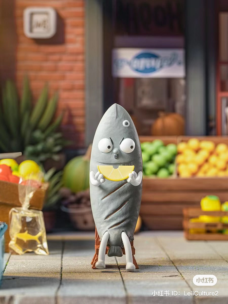 What the Man Daily Blind Box Series toy holding a lemon slice, with a logo and fruits in the background.