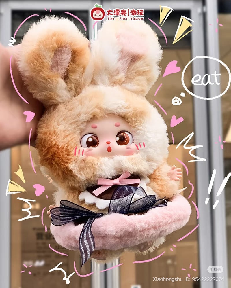 Plush rabbit toy Baby Three - Little Fatty - What Should I Eat Today with oversized ears and pink bow, surrounded by playful accents on a pink cushion.