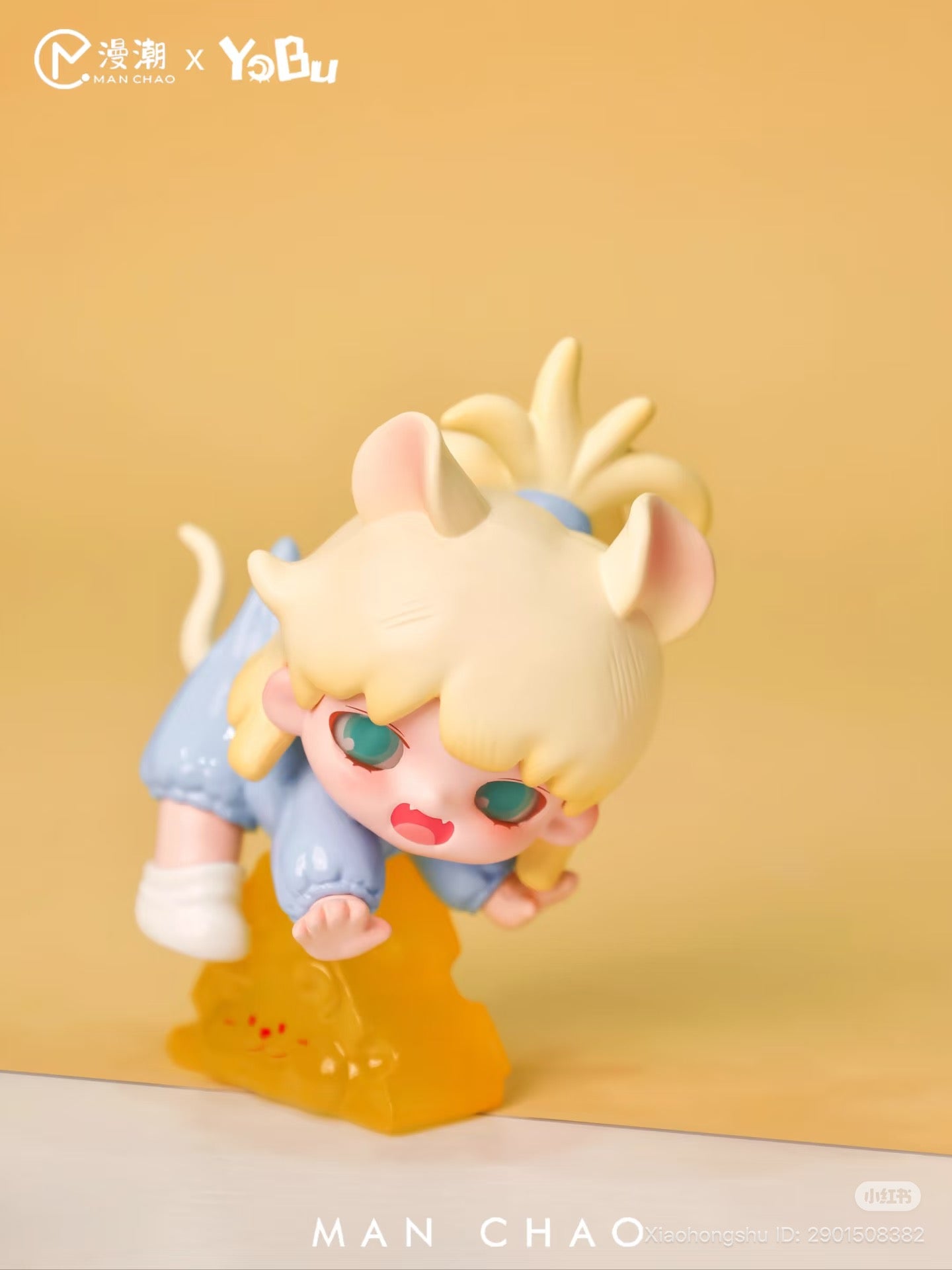 YOBU - It's A Bit Sweet Blind Box Series: Chibi figure with mouse ears, teal eyes, sky-blue loungewear, posed on amber base with cat-face detail.