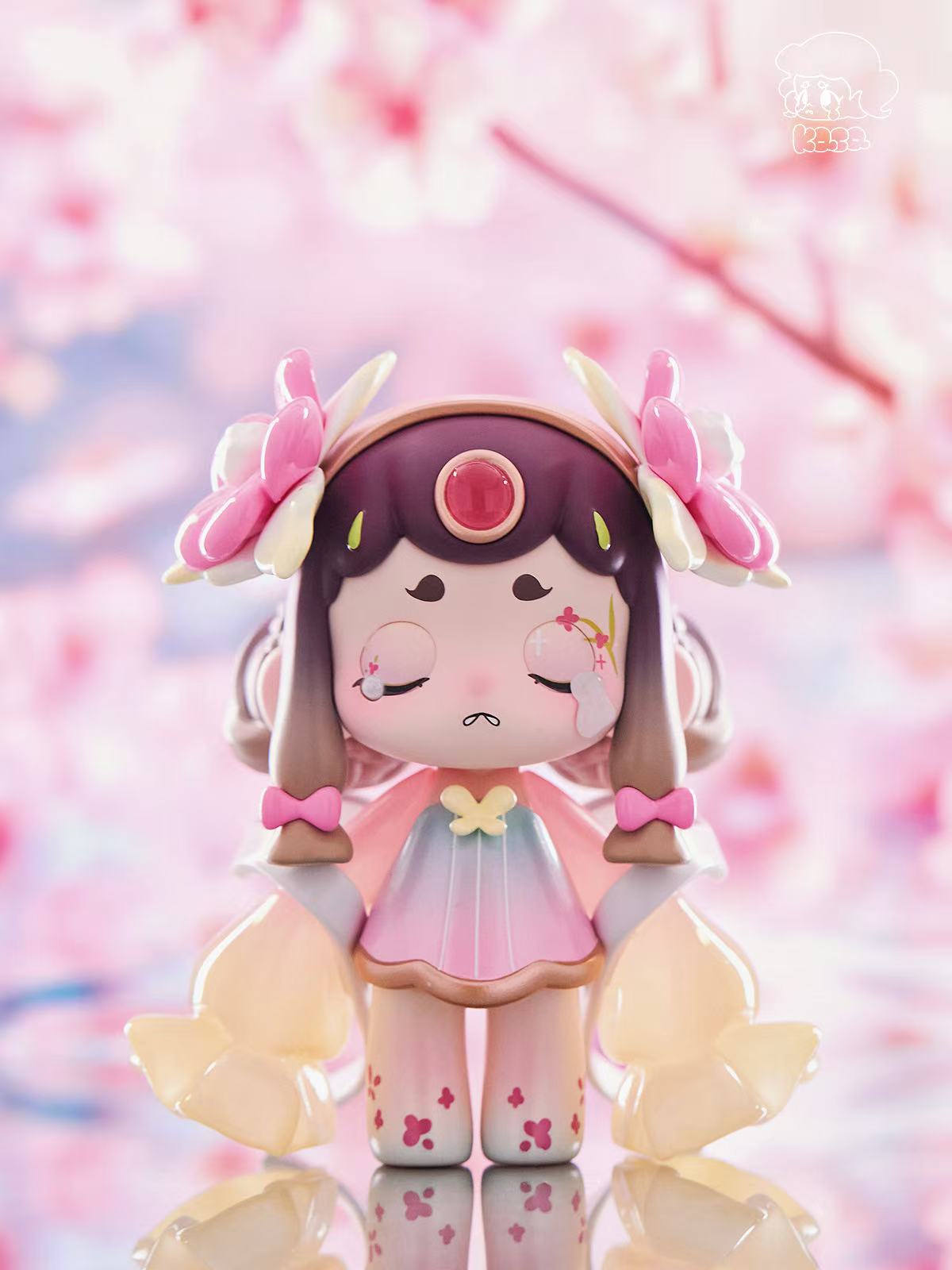 KASA 2.0 - Mystic Tales Blind Box Series: Chibi-style vinyl figurine with closed eyes, pleated dress, flower hairpieces, gradient pigtails, jewel, and glossy wings.