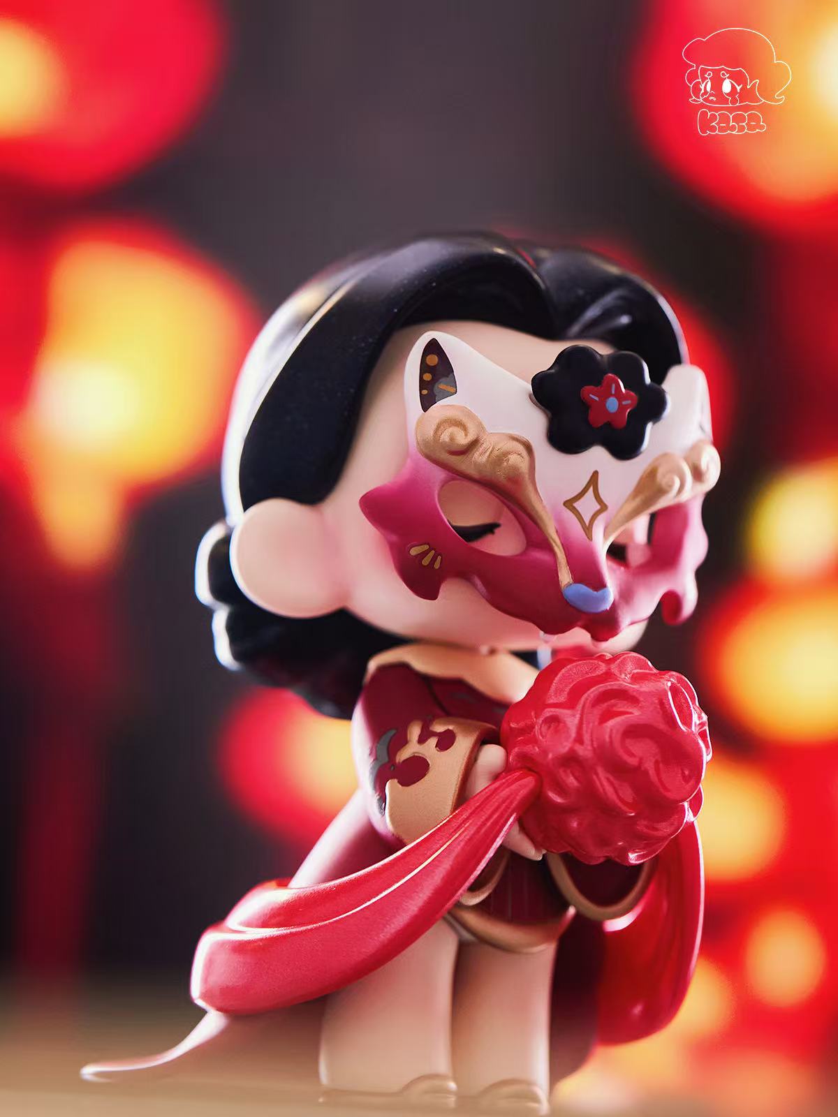KASA 2.0 - Mystic Tales Blind Box Series figurine, chibi-style with black hair, red-and-gold outfit, cat-ear mask, holding a red pomander and ribbon.