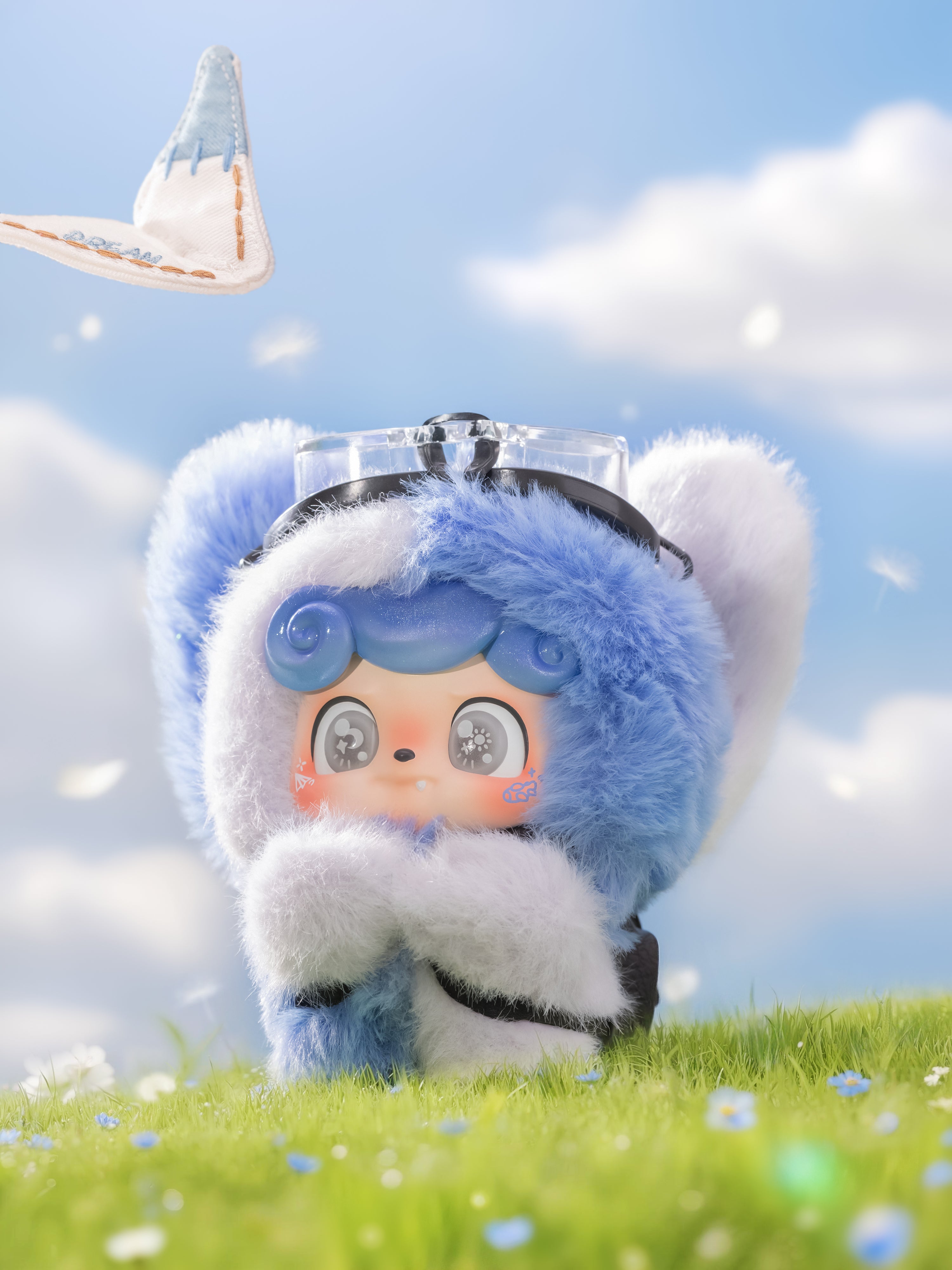 Cartoon-style figure in a blue bear suit with goggles from Q. Kid Outdoor Activities Series PVC Plush Blind Box, sitting on grass with floral accents.