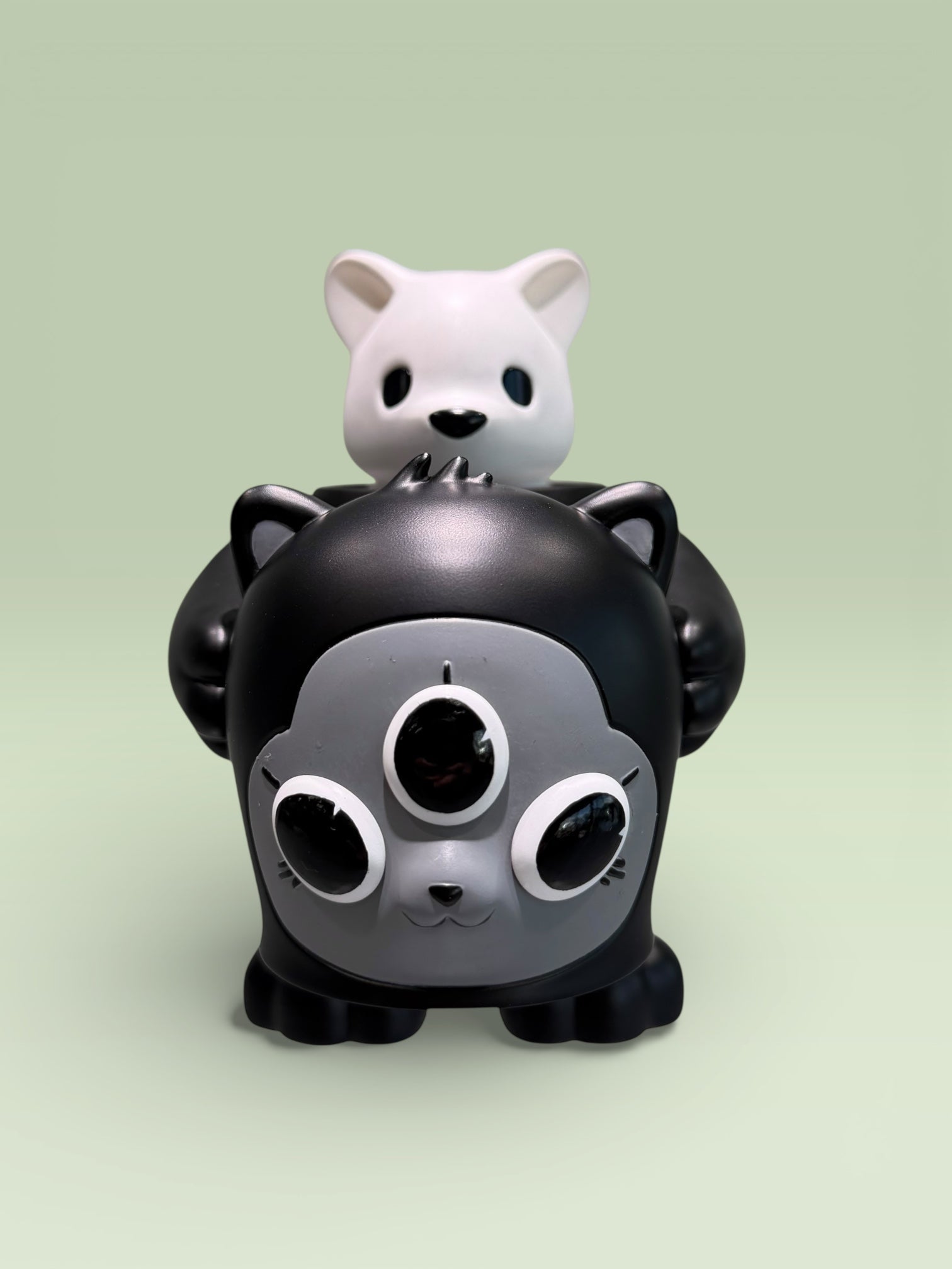 CollectedCon Luke Chueh Beans Exclusive - Preorder features a dark creature topped with a white cat figure, both vinyl-style, limited to 50 pieces.