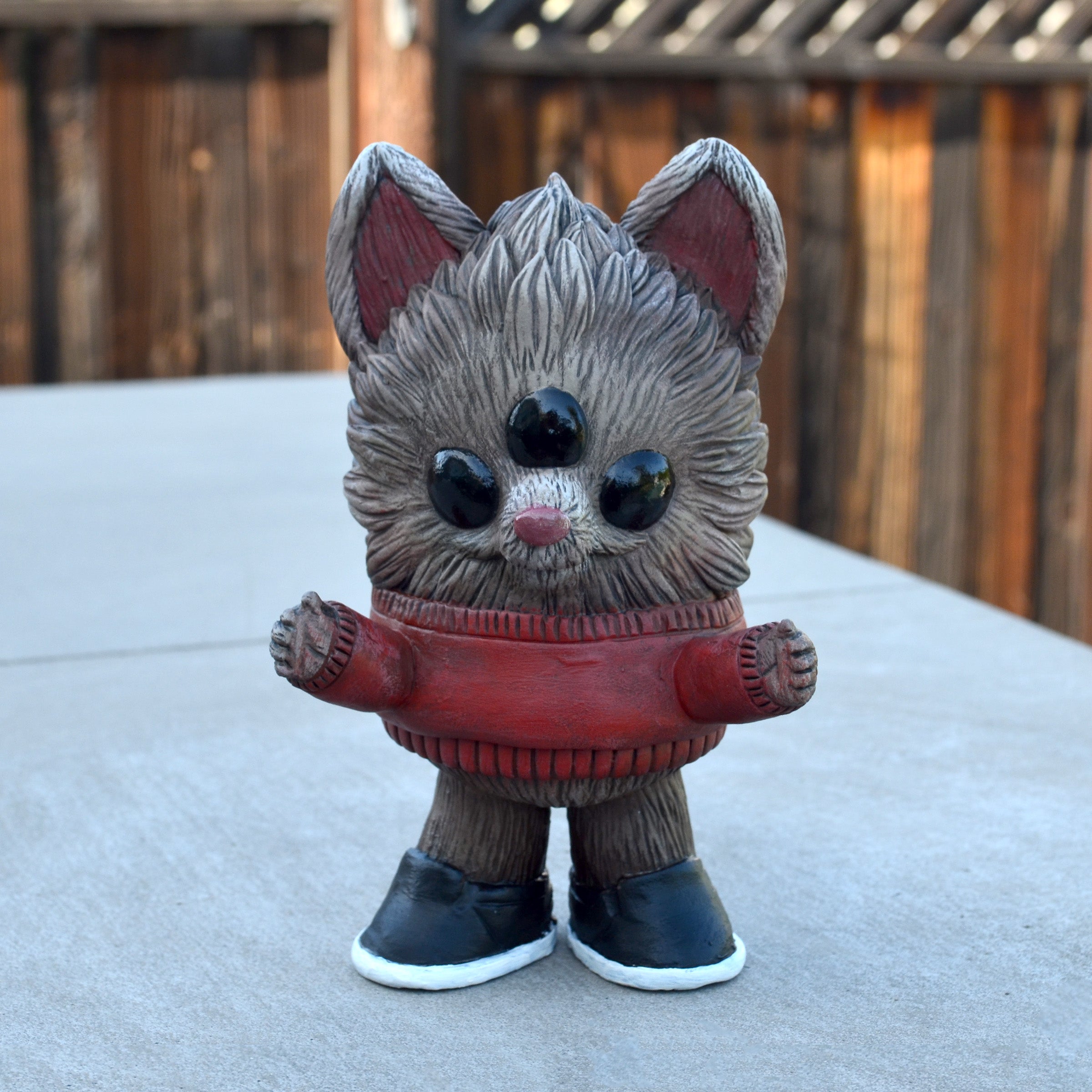 Beans Group Show - Reynard by Vanessa Ramirez x Josh Divine: A 4x3x6.25in vinyl figurine of a stylized creature in a red sweater, featuring glossy forehead gems. Preorder available.