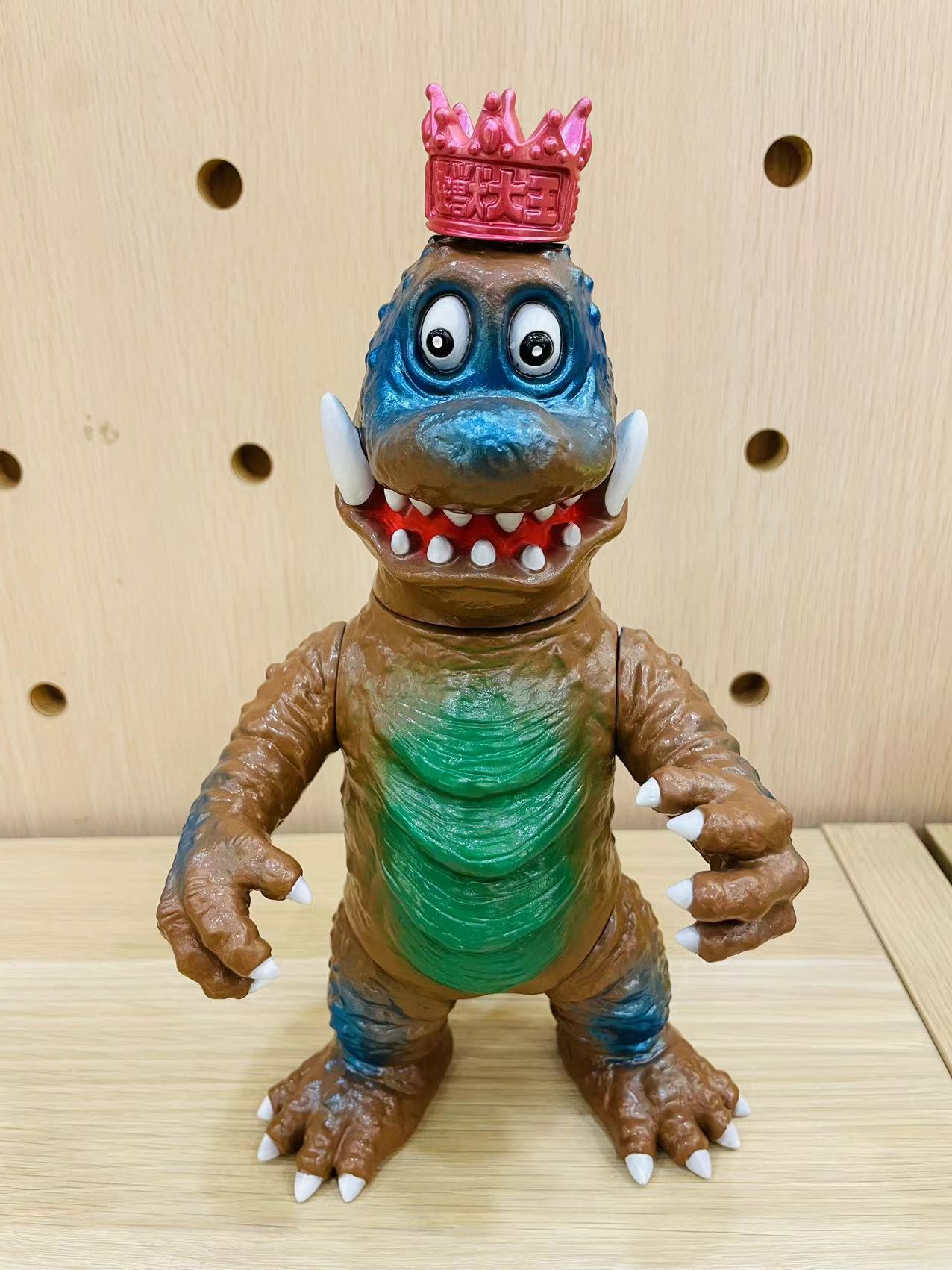 Picopico 怪獣大王 Manga toy dinosaur figurine with a red hat, Sofubi material, 24cm height, displayed on a table for Strangecat Toys.