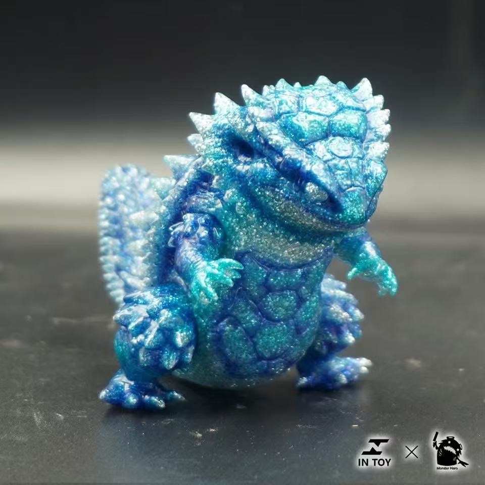 Mini Ultra Beast sofubi - shine .Ver, a 7cm translucent, glittery reptilian collectible toy with movable head, hands, feet, featuring a turtle-like shell and spiky scales.