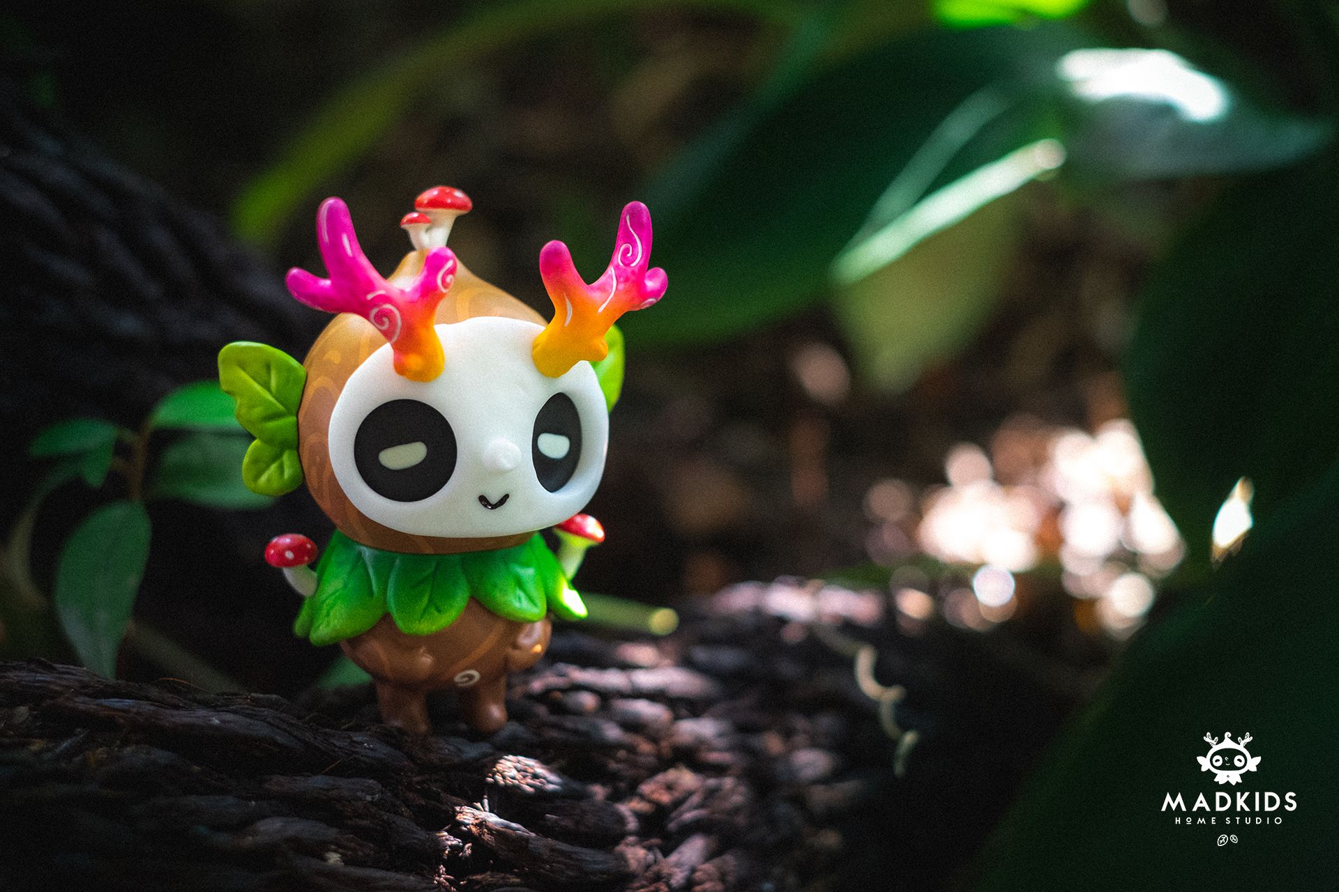 Ori Muffinn: The Wooden Brown figure with mask face, antlers, and mushrooms, posed on a log. Preorder for June 2026, resin, 9.5 cm tall.