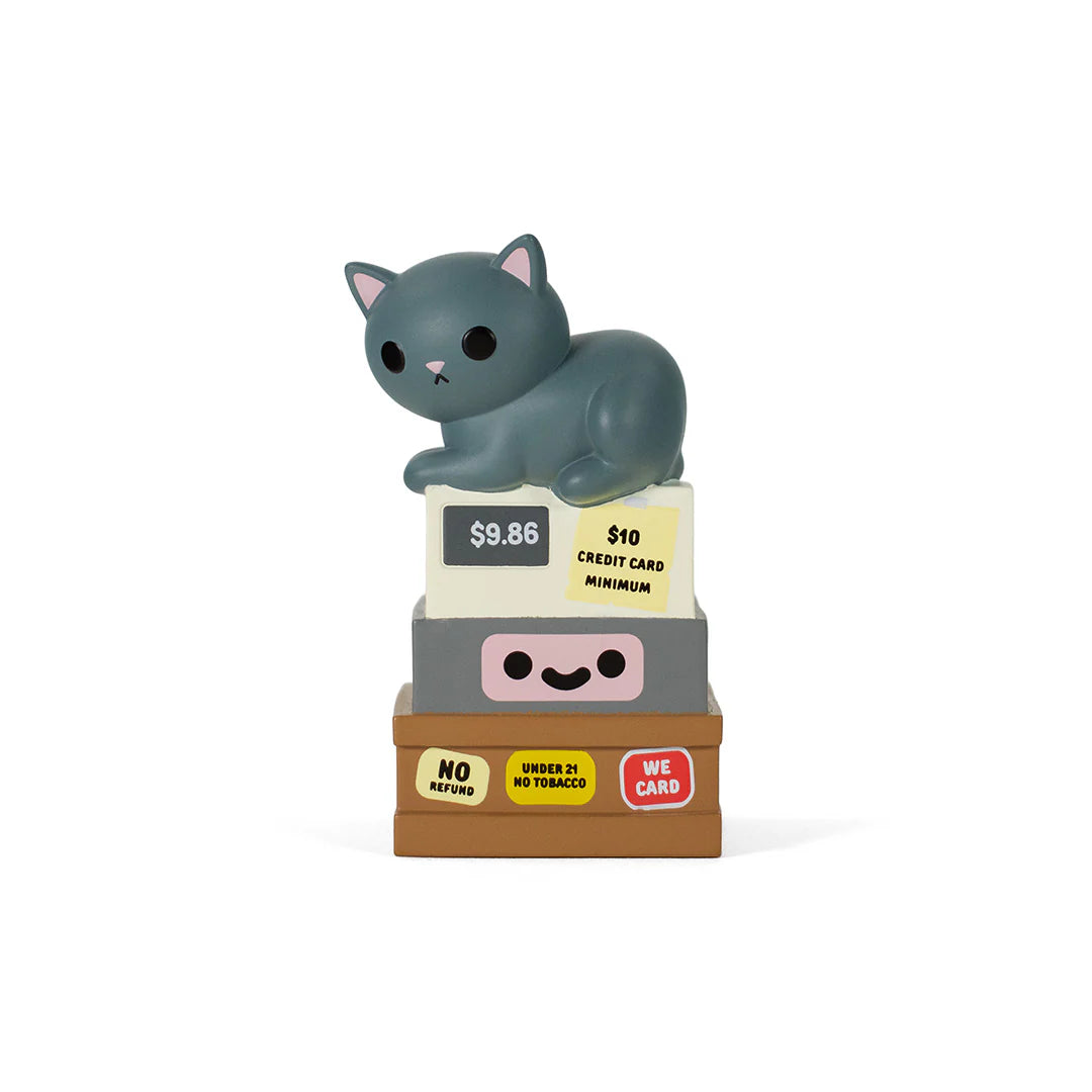 Bodega Kitties Mystery Series 2 by 100% Soft: A gray cat vinyl figure rests on miniature cash registers with playful store-themed stickers. Collectible blind box art toy.