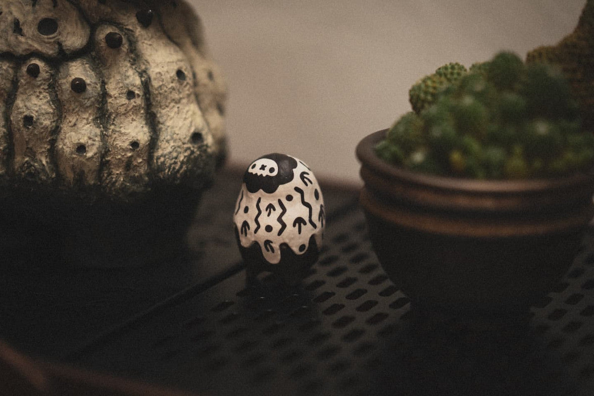 Copiapoa Mudball Blind Box Series by Robin Huang features intricate miniature skull-themed vases, highlighting unique plant designs in a collectible set.