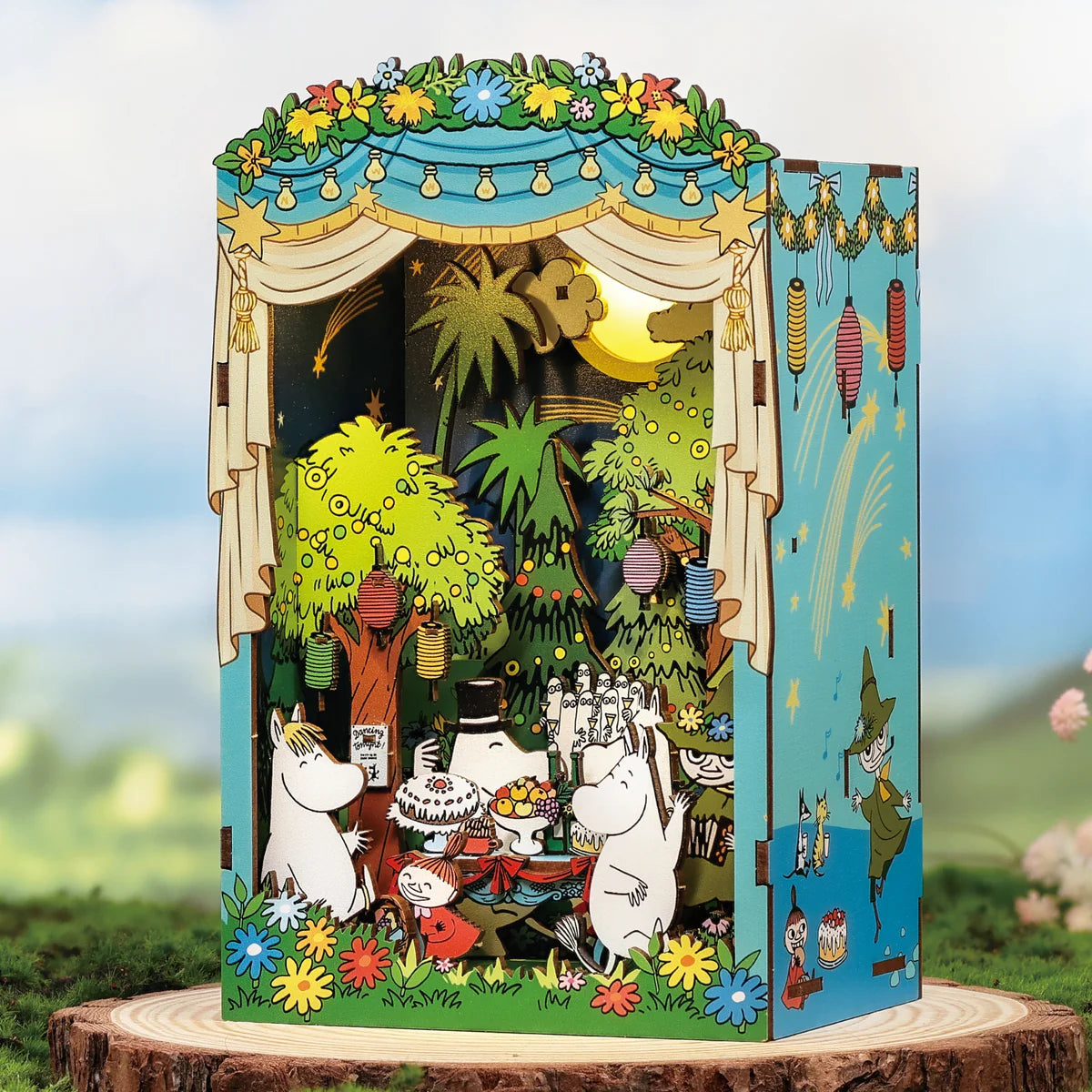 Moomin Moominous Dance Party pop-up diorama featuring Moomin characters celebrating in a whimsical forest setting, complete with LED lights and intricate details.