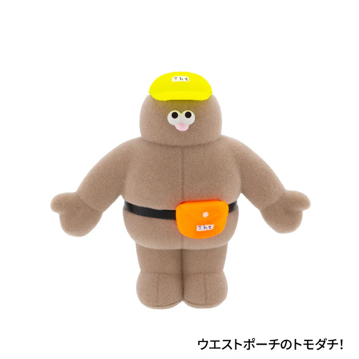 Plush-style character from The TOMODACHI! Figure Collection Vol. 2 Gacha, featuring big eyes, yellow cap, and fanny pack with Japanese text Waist-pouch friend!.