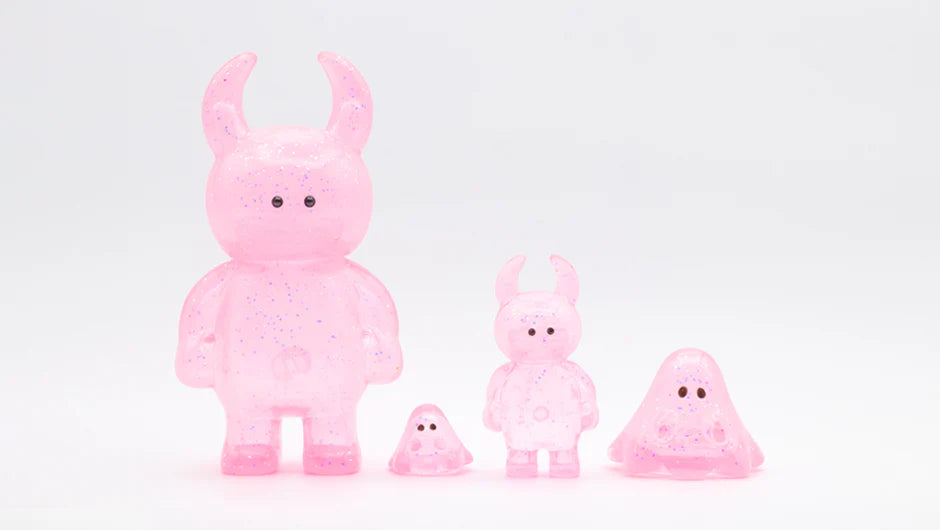 UAMOU CLEAR PINK GLITTER figurines, featuring bunny-horned and blob-like designs, crafted from translucent vinyl with glitter, showcasing varied sizes and playful shapes.