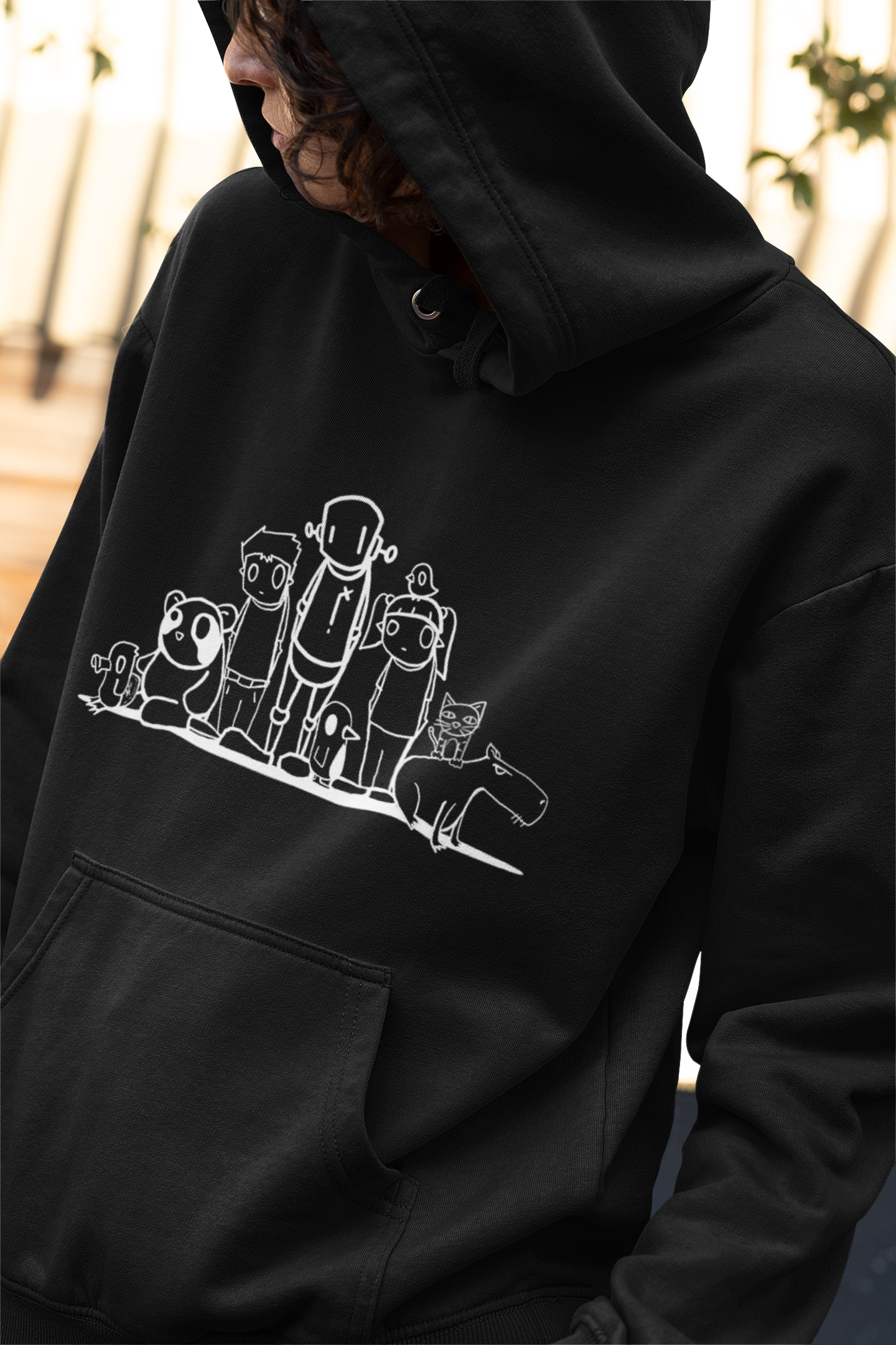 Person in Like an old friend - Hoodie by ChrisRWK with cartoon characters, close-up of fabric and button.