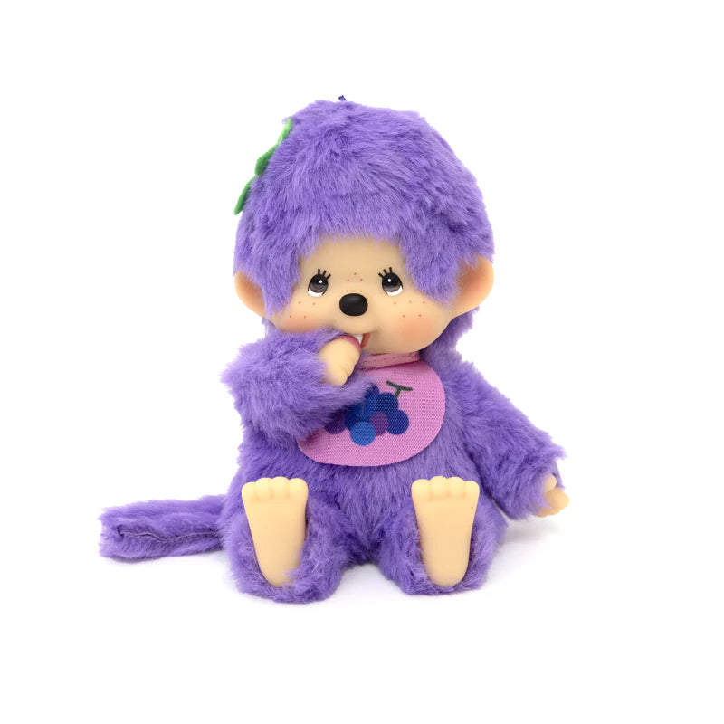 Monchhichi Fruit Beanies Plush doll, 5.5, with purple fur, vinyl face, and grape-themed bib, thumb-in-mouth pose, reflecting Strangecat Toys’ unique art toy collection.