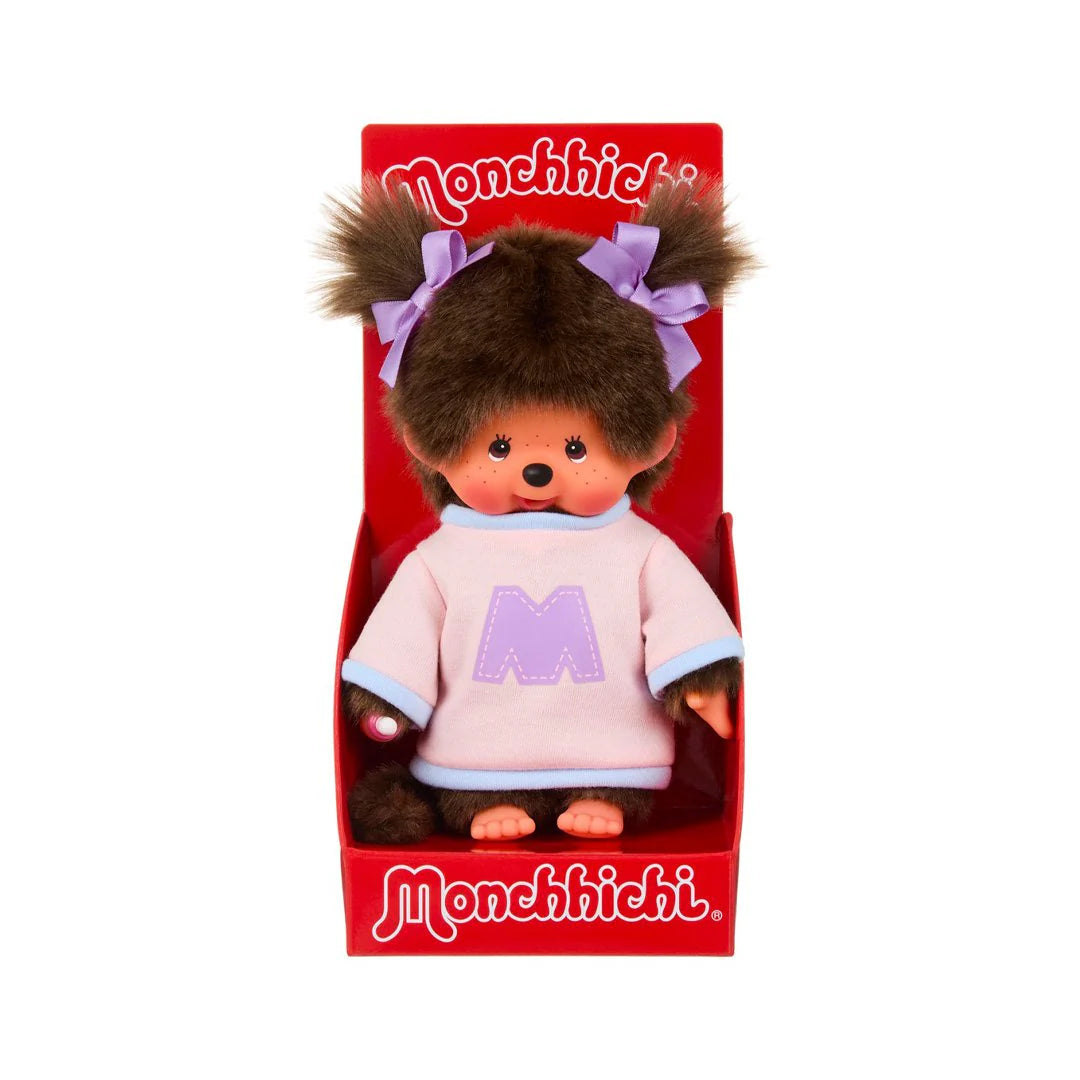 Monchhichi Girl - Bi-Colored Sweater Plush Toy in red display box, featuring plush fur, embroidered bib, and stylish two-tone sweater with lavender-ribboned pigtails.