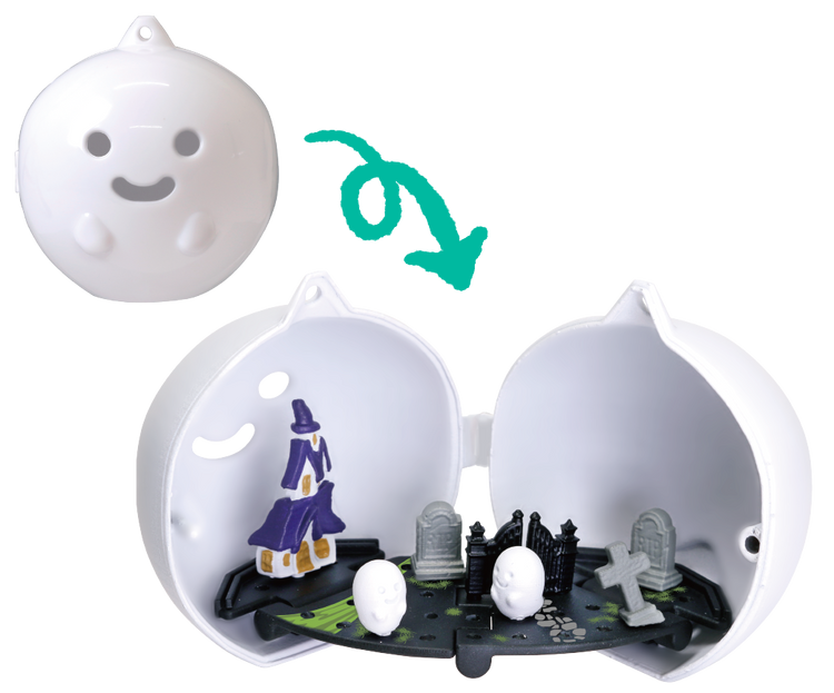 2-Way Halloween Ornament Gacha Series capsule reveals a miniature purple haunted house diorama with ghosts, gravestones, and a winding path inside.