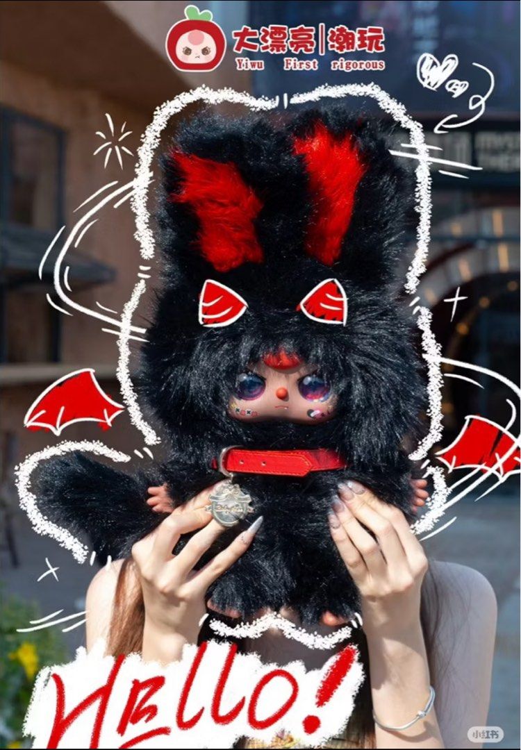 Migo Twins 400% plush doll in fluffy black fur with red accents and bat wings, held by a person, decorated with playful doodles and branding.