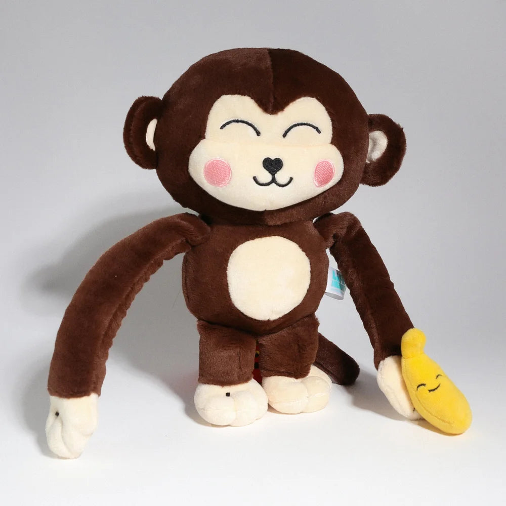 Monkay plush toy with a smiling face, holding a smiling banana accessory. Made of soft fabric with magnets in hands. Suitable for ages 0+.